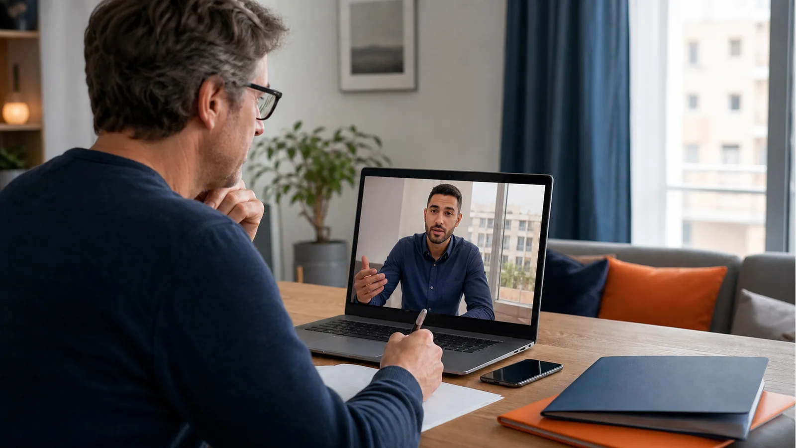 Overseas property owner discussing a remote sale with a local adviser by video call.